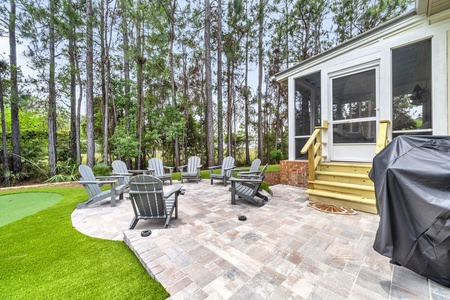 A spacious paver patio with comfortable Adirondack chairs, perfect for morning coffee or evenings under the stars.