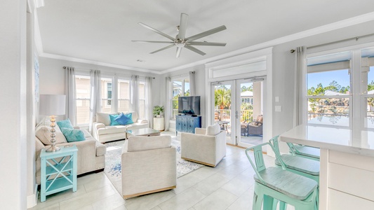 The main living room offers sweeping views of the pool!