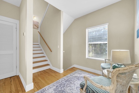 Step into your welcoming foyer, where warm hardwood floors and soft natural light set the tone for a relaxing stay. The staircase beckons you upstairs to discover comfortable spaces designed just for you.