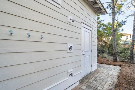 Enjoy a convenient outdoor shower, with towel hooks, and beach gear storage closet.