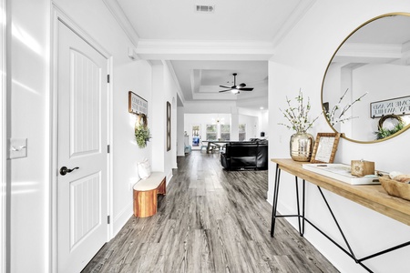Step into your stylish entryway where warm wood floors and thoughtful touches create an instant feeling of home.