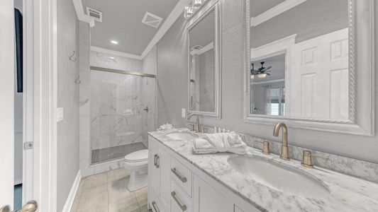 The Jack-n-Jill bathroom on the ground floor offers dual vanities and a walk-in shower!