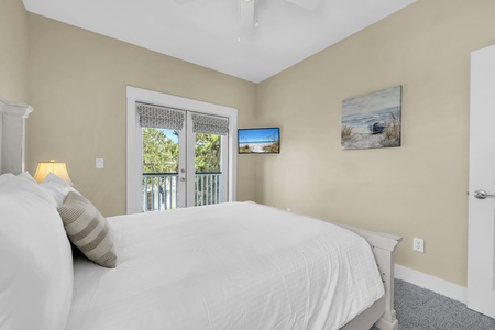 Wake up to natural light streaming through French doors that open to your private balcony, where lush greenery frames the view and fresh air invites you to start your day feeling refreshed.