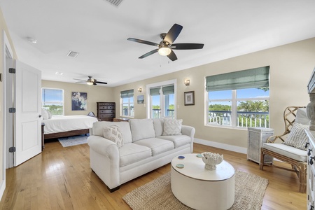 Unwind in your spacious suite where peaceful water views greet you through every window, and soft coastal breezes keep you comfortable overhead.