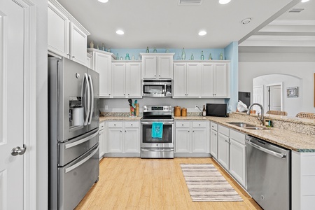 The well-equipped kitchen features stainless appliances and granite countertops!