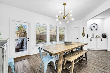Gather around this charming farmhouse dining table where your group can share memorable meals beneath the stunning starburst chandelier.