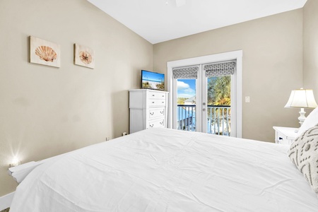 A second queen bedroom on the 2nd floor, with French doors opening to the balcony.