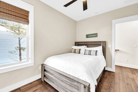 Drift off peacefully in your comfortable bed beneath exposed beams, with soft natural light filtering through bamboo blinds.