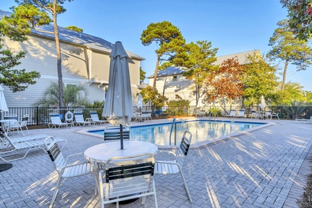 Dive into your private pool oasis, surrounded by lush trees and comfortable loungers for the perfect sunny afternoon retreat.