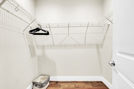 Your spacious walk-in closet offers organized wire shelving and warm wood floors to keep your belongings perfectly arranged.