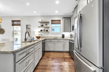 Your spacious kitchen features granite countertops, stainless steel appliances, and ample prep space for cooking memorable meals together.