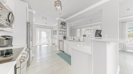 The fully stocked kitchen includes a breakfast bar and quartz countertops!