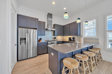 The kitchen features stainless appliances and quartz countertops!