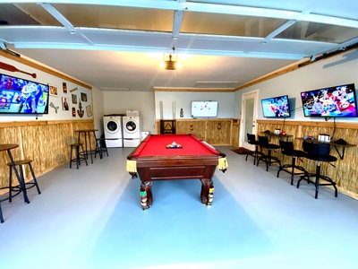Tiki-bar styled game room with pool table and Nintendo gaming wall!