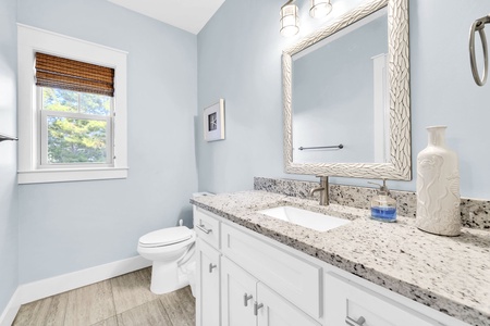Refresh in your elegant bathroom with granite counters, designer mirror, and soothing blue walls that create a spa-like sanctuary.