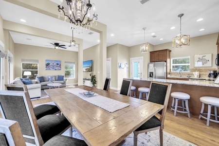Gather around the spacious dining table where shared meals become treasured moments, then relax in your open living area where elegant chandeliers and vaulted ceilings create an inviting atmosphere for your vacation.