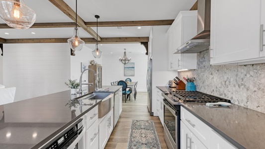 The kitchen features modern finishes and a gas range!