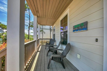 A shaded balcony and porch offer a wonderful place to soak up the beach breeze!