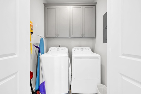 Keep your clothes fresh with this dedicated laundry room featuring full-size washer and dryer plus ample storage.
