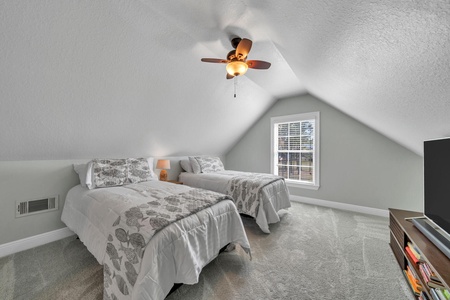 The loft bedroom features two twin beds and a flat screen TV!