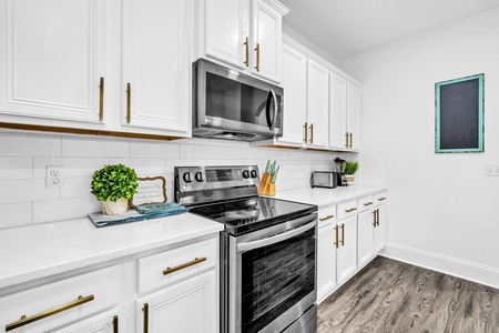 Your pristine kitchen features modern stainless appliances and elegant white cabinetry, ready for your culinary adventures.