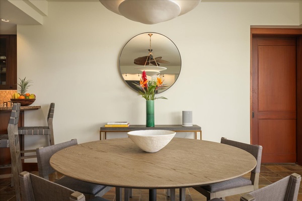 The mirror echoes the circular dining table and lighting fixture.