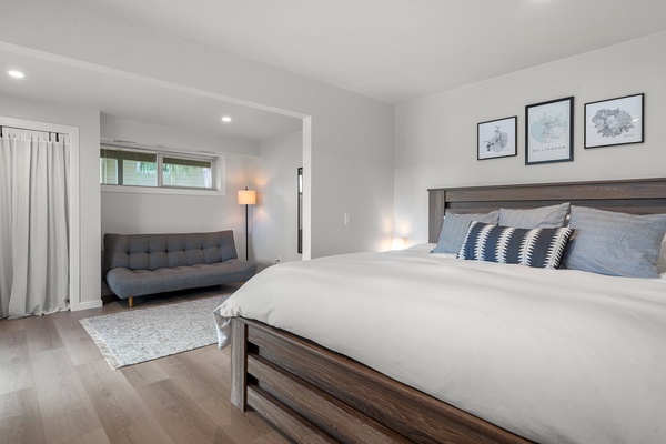 Elegant primary bedroom with a king-sized bed and a cozy adjoining sitting area.