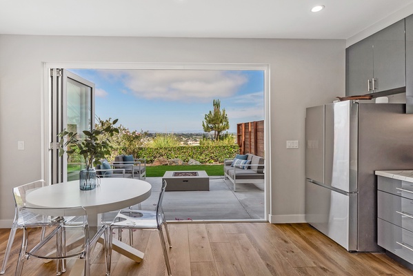 Dining table with seating for four with indoor / outdoor living space.