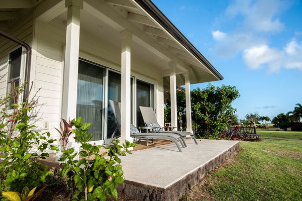 Primary Bedroom Lanai with lounge chairs and golf course and sunset views