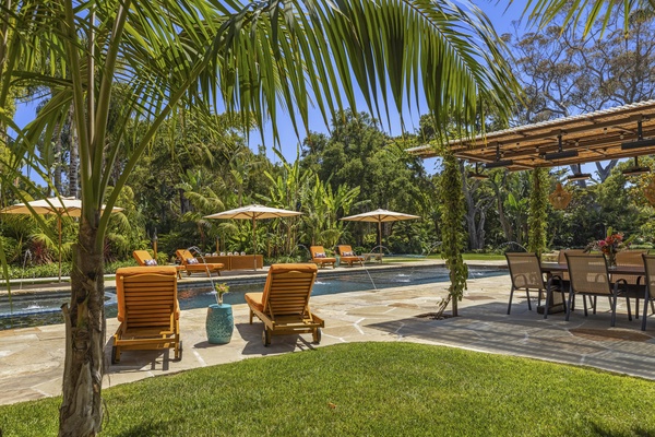 Enjoy a cool drink on the loungers by the pool and soak up the lush green views.