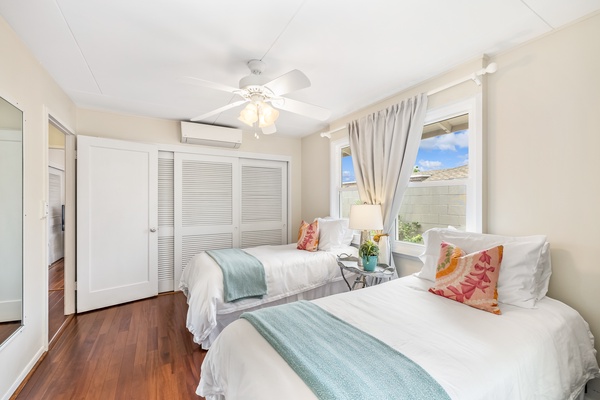 The guest bedroom features two twin beds and split AC.