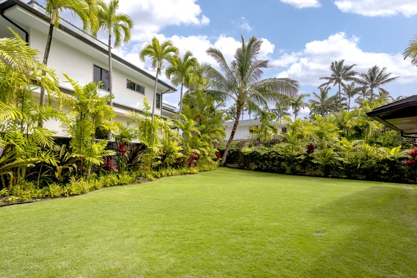 Lush green backyard provides privacy and tropical landscaping