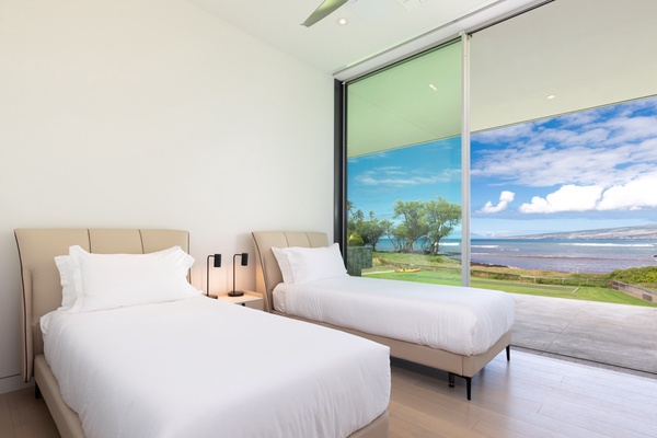 Wake up to serene ocean views in this luxury guest bedroom, perfectly designed for relaxation.