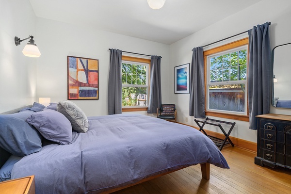 The master suite is filled with natural light, thanks to an abundance of windows, creating an open and inviting space.