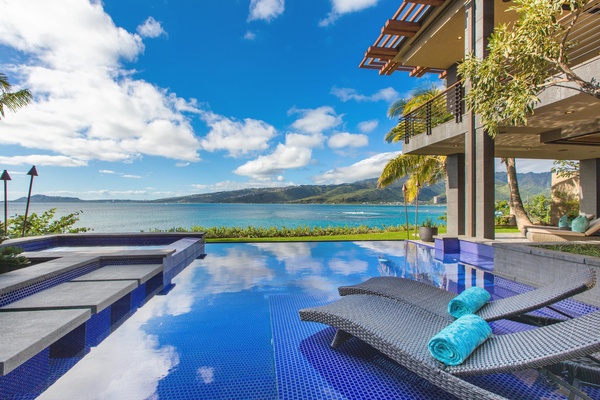 Infinity pool with chaise lounge chairs.