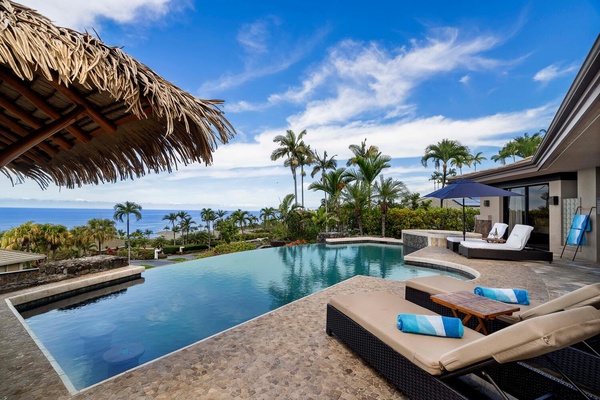 Lounge in our poolside chaise lounges, inviting you to relax and savor the island sky.