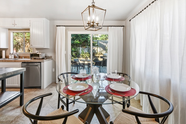 Elegant dining glass table for four with easy access to the patio.