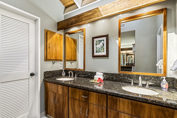 Dual vanities with granite counters in the primary bathroom