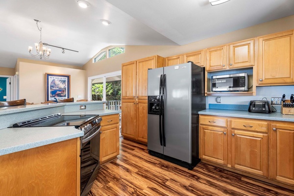The spacious kitchen area has top tier stainless steel appliances.