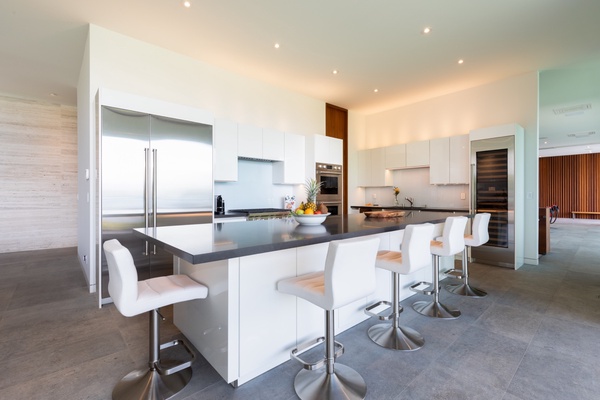 The modern kitchen features expansive counter spaces and top-tier appliances for convenient meal prep.