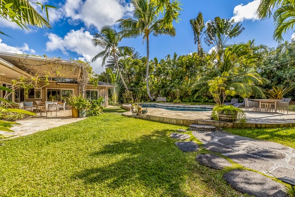 Enjoy the beautifully manicured lawn and tall palm trees