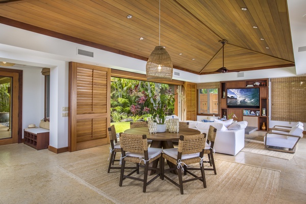 Indoor dining area for 6 with a view of the exterior courtyard & pond features