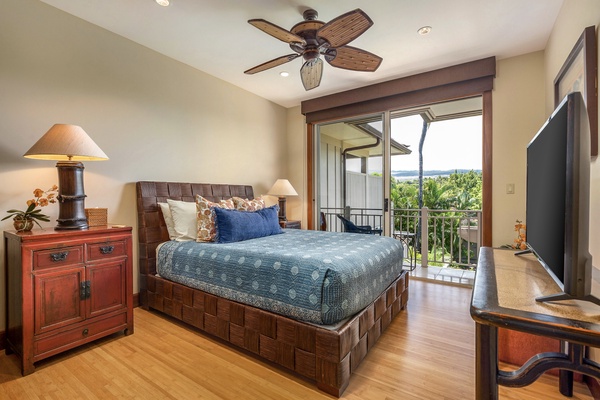 Upstairs guest room with queen bed, flat screen TV, balcony and adjacent bath.