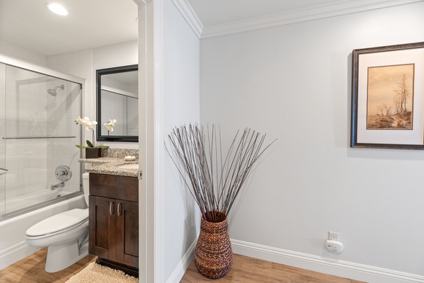 Directly down the hall is the guest bath with a step in shower/tub with sliding glass doors