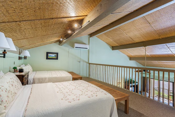 Cozy loft with two queen beds, offering a comfortable sleeping space.