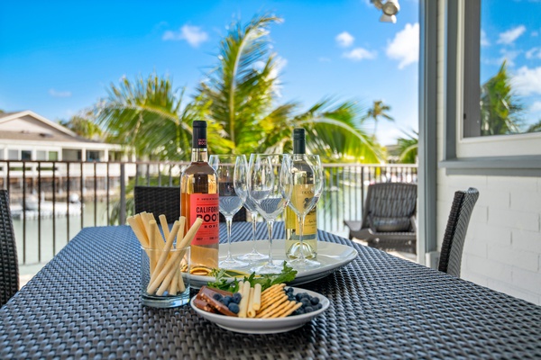 The outdoor dining table on the lanai, facing the marina canal.