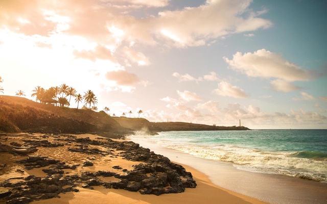 A portion of the breathtaking beach at Hokuala, with Ninini Point Lighthouse in the distance.