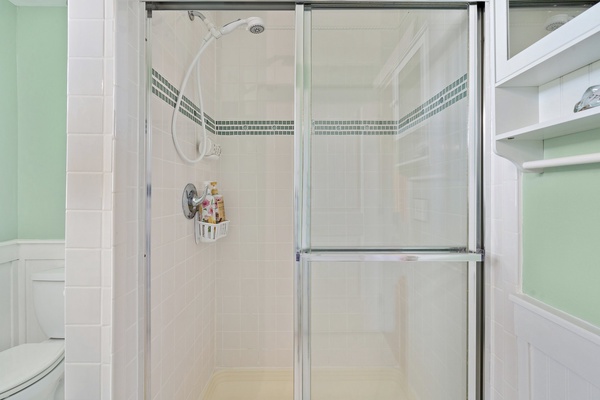 Spacious bathroom with sleek shower sliders for added privacy