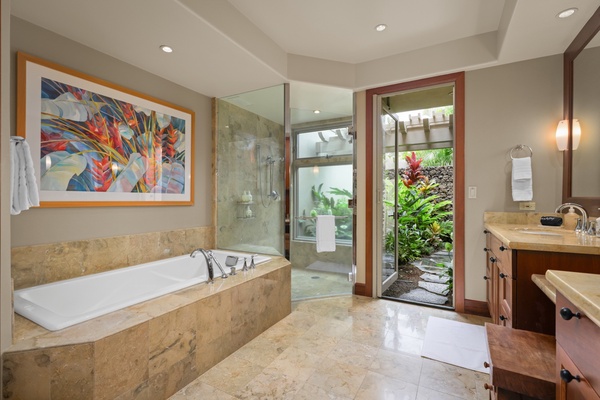 Elegant primary bath with dual vanities, large soaking tub, and glass enclosed shower.