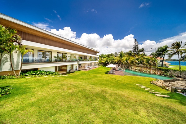 Expansive backyard with manicured lawns and direct access to the infinity pool.